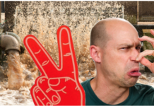Man holding nose with foam number 2 hand in front of bursting sewage pipes