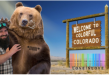 Bearded man with beard hugs smoking bear with Jeep tattoo in front of "welcome to Clolorado" sign and Love is Love rainbow barcode