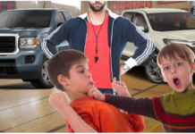 Children fighting in front of gym teacher with 2019 GMC Canyon and Honda Ridgeline in back