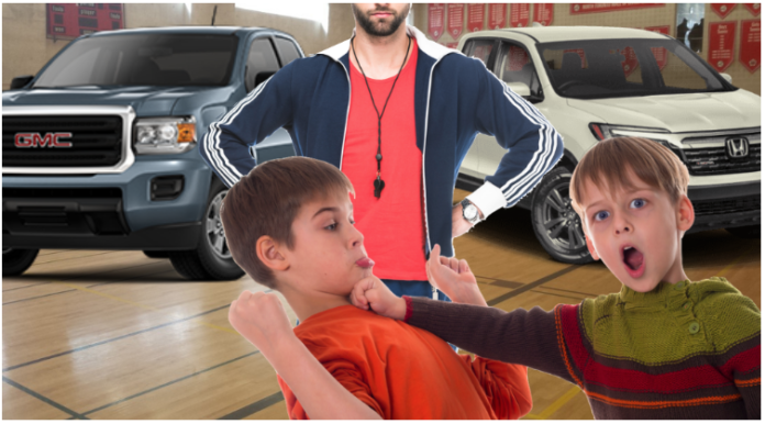 Children fighting in front of gym teacher with 2019 GMC Canyon and Honda Ridgeline in back