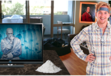 Man with tie on head in room with painting of Ben Franklin, TV shows Mr. Freeze from Batman, pile of cocaine on table