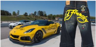 Man wearing baggy jean shorts with Ed Hardy across the rear, yellow 2019 Chevrolet Corvette with Ed Hardy text in back