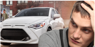 White 2019 Toyota Yaris in back with depressed man in front
