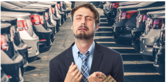 Man crying holding discount tag in front of rows of cars