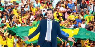 A man in a suit in front of a Brazilian crowd