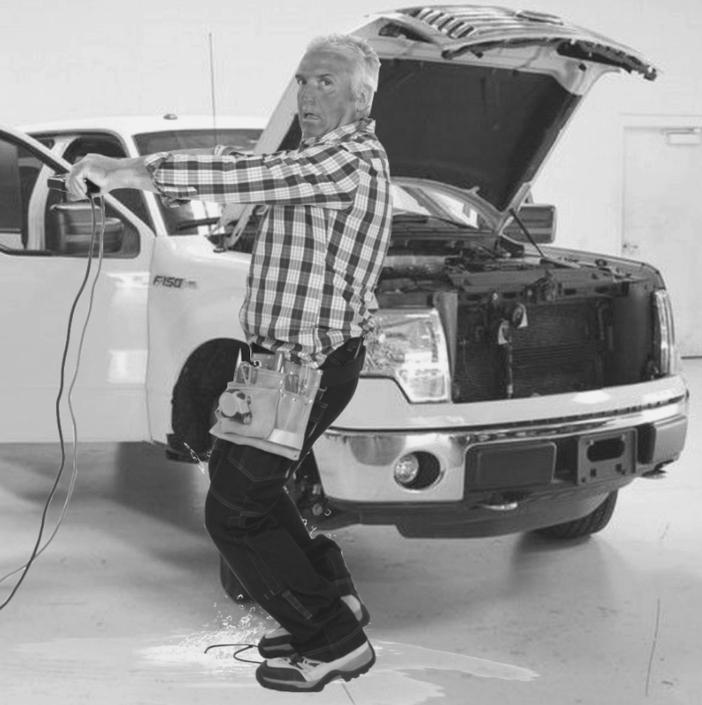 Black and White image of a man working on a truck