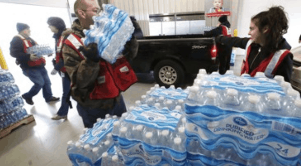 Crew loading cases of bottled water