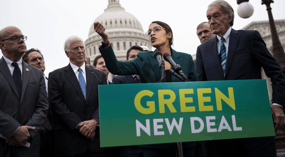 Rep. Alexandria Ocasio-Cortez discusses her ‘Green New Deal’ with several male politicians around her.