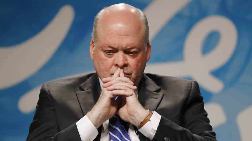 Jim Hackett is shown stressed, because Ford dealerships are struggling, with his hands crossed in front of his mouth.