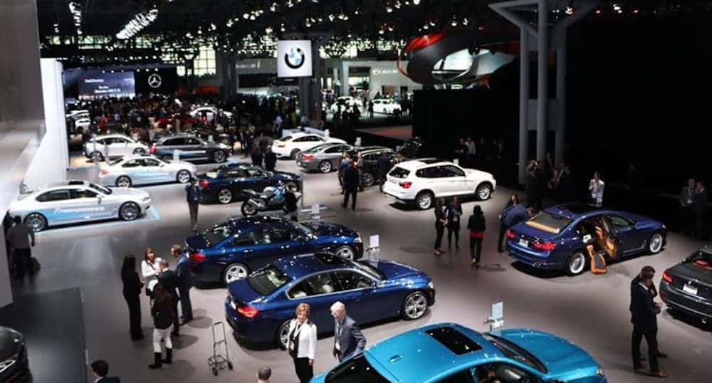 An image from the 2018 NYIAS is shown featuring a car showroom. The 2019 show happed in March and is popular in live auto news.