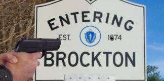 A policer officer's hands holding a pistol are shown in front of an entering Brockton, MA sign.