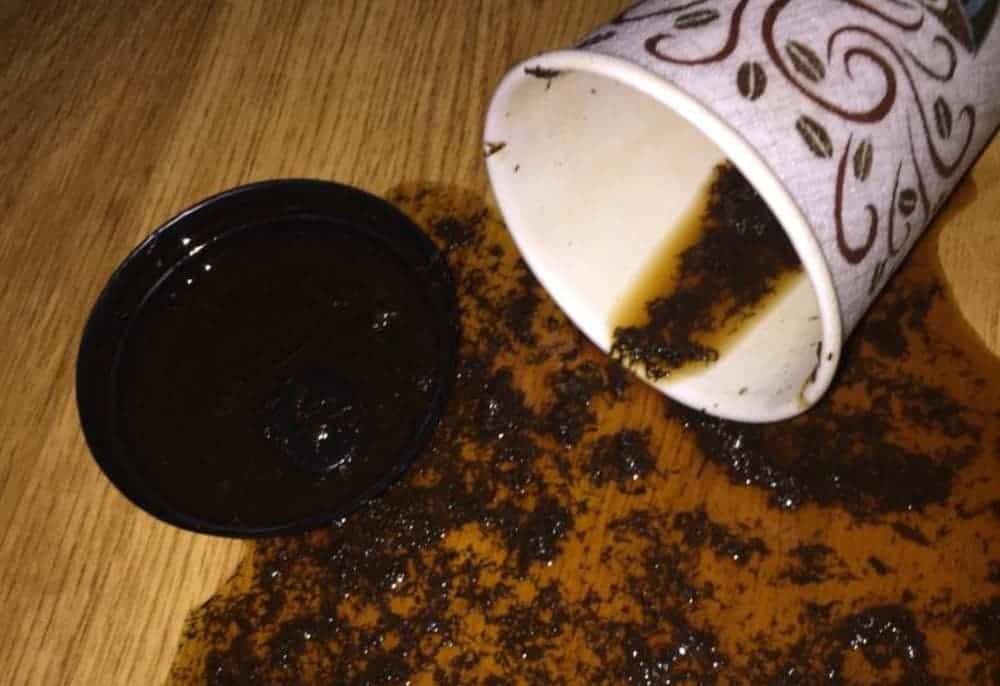 A disposable coffee cup filled with dip is spilled.