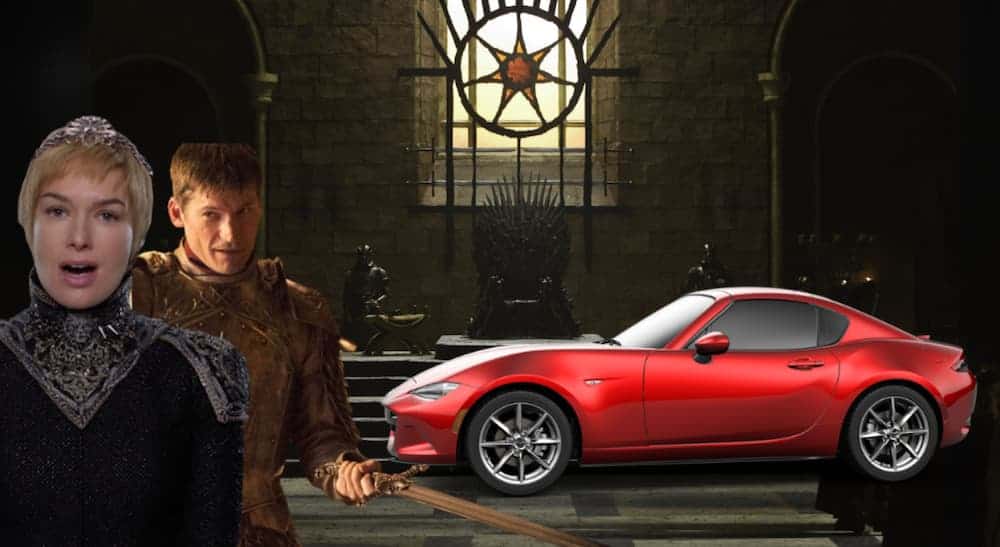 Two Game of Thrones characters are next to a red Mazda Miata.