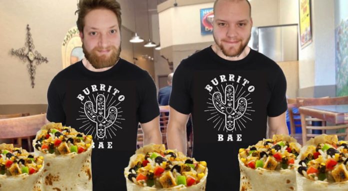 Two men in Burrito Bae shirts are in a restaurant with burritos in front of them.