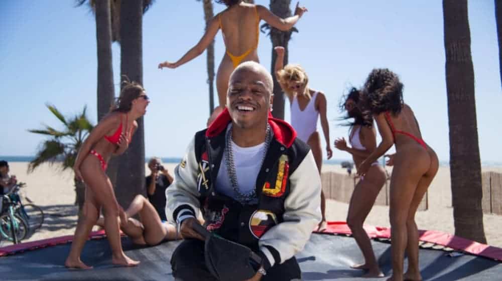 A screenshot of the 'Thong Song' by Sisqo features him and women in thongs on a trampoline.