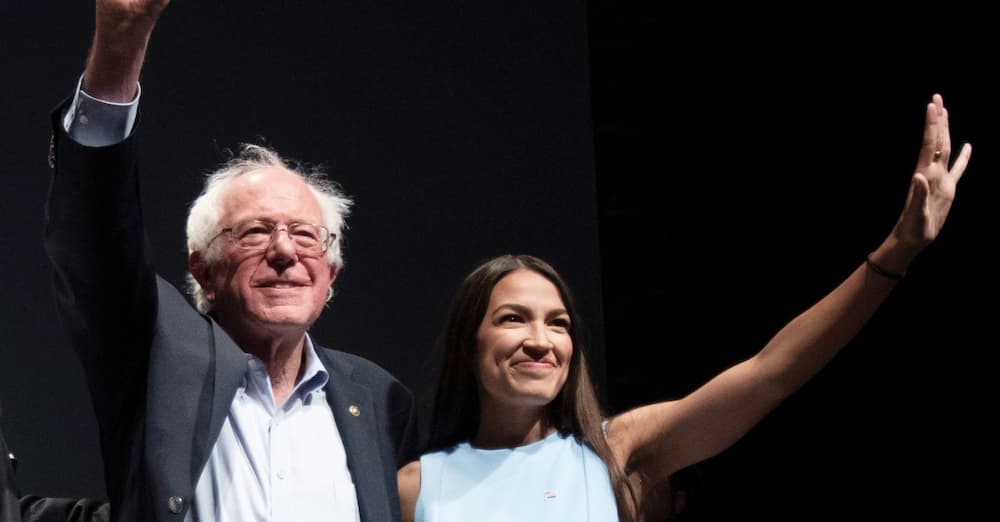 Bernie Sanders shown with NY Congresswomen Ocasio-Cortez with a black background.