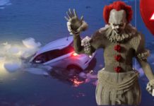 Pennywise is waving while a car sinks into a frozen lake.
