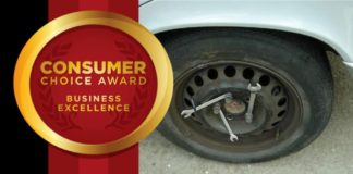 A car with a donut rim covered in wrenches has an award shown for Consumer Choice for Business Excellence.