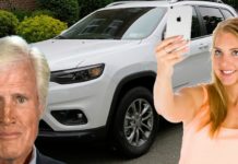 A woman is taking selfies with her Jeep Cherokee, which aids in the 2019 Ford Edge vs 2019 Jeep Cherokee comparison.