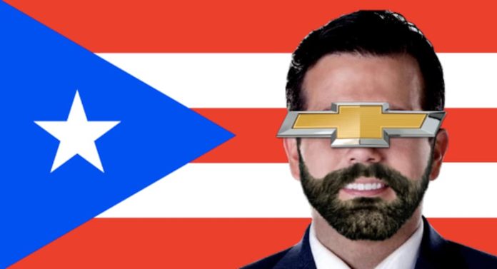 The Chevy symbol is over Rosselló's face in front of the Puerto Rican flag because his old Suburban may be a valuable used car for sale.
