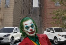 Joaquin Phoenix's Joker is shown in front of the 2020 Ford Escape and 2020 Chevy Equinox on a city street.