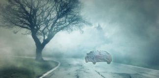 A ghost car that has been mentioned in live auto news is driving on a foggy road at night.