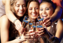 A group of women at a party with champagne glass with the Ford logo on them