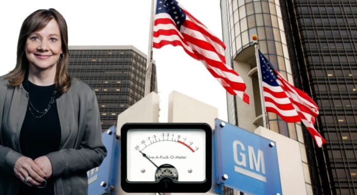 A woman is next to a zero f*cks meter in front of the GM building.