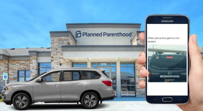 A phone with a meme on it is in front of a Nissan Pathfinder and Planned Parenthood, which is helping people decide between the 2020 GMC Acadia vs 2020 Nissan Pathfinder.