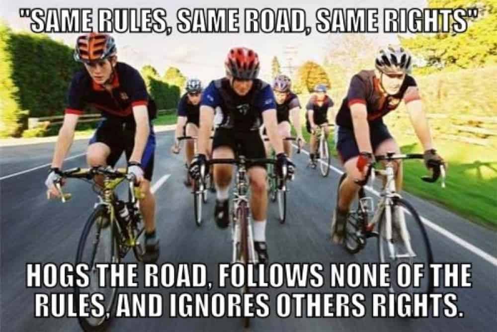 A meme about cyclists hogging the road is shown.