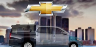 A 2021 Chevy Subavark, which is part 2020 Chevy Spark and part Suburban, is under the Chevy emblem in front of a city skyline.