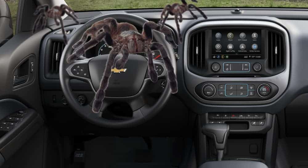 Spiders are crawling on the dashboard of a 2020 Chevy Colorado during a 2021 Chevy Colorado vs 2020 Chevy Colorado comparison.