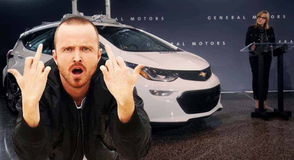 Jesse Pinkman is giving middle fingers in front of a Chevy car at a GM press conference for GMC trucks for sale.