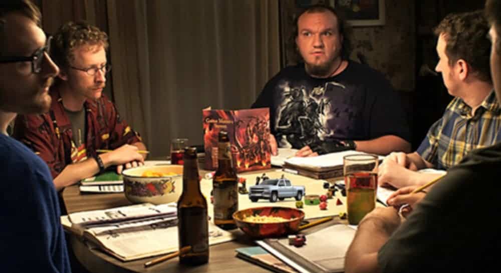 Men are around a table playing D&D with a mini Chevy trucks and beers.