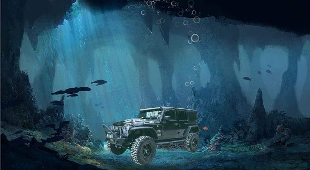 A Jeep Wrangler Unlimited is shown in an underwater cave.
