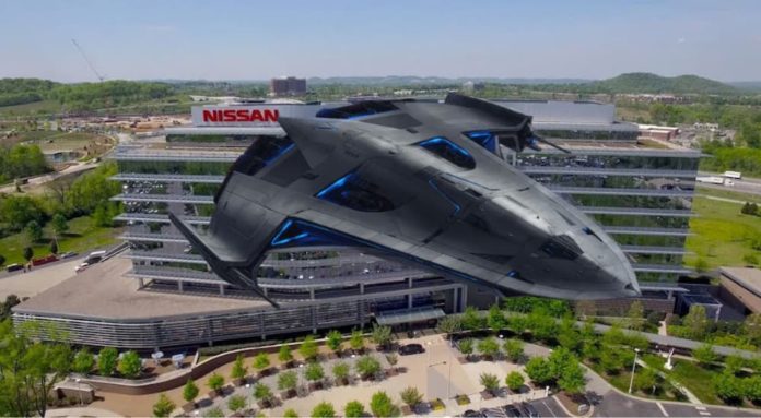 A spaceship is shown in front of the NIssan headquarters.