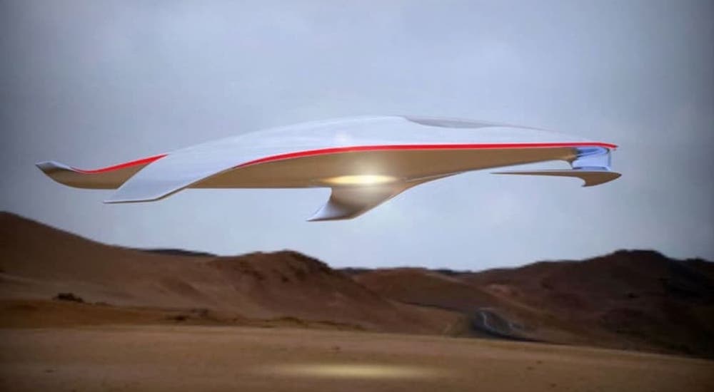 A spaceship is floating above a desert.