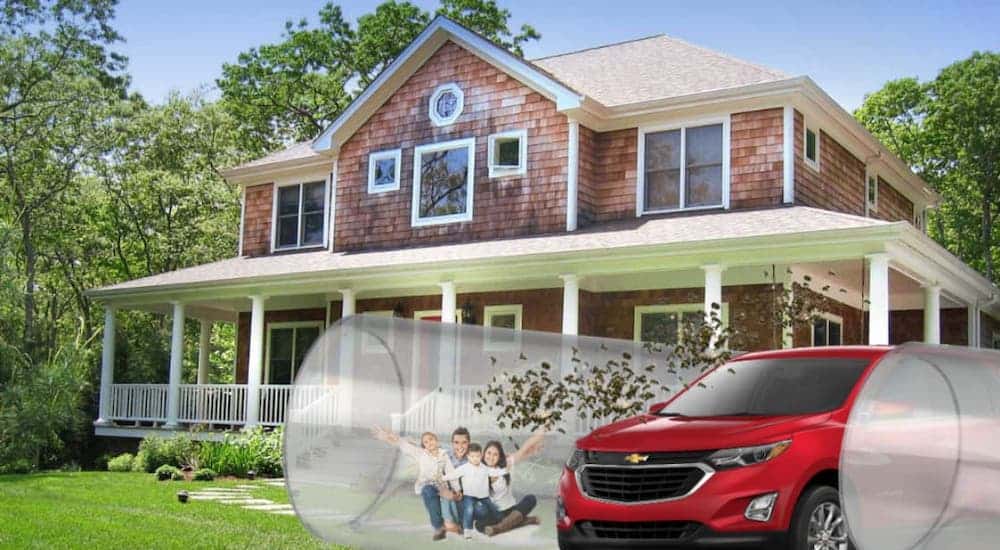 A family has a wind tube full of murder hornets and a red 2020 Chevy Equinox in the driveway of their red brick home.