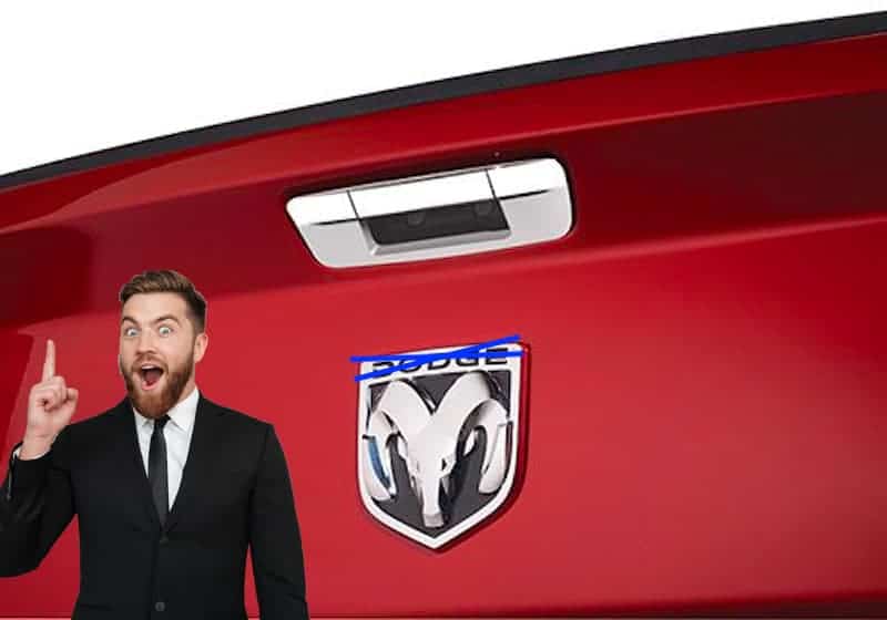 A closeup shows a Dodge Ram tailgate with the word 'Dodge' crossed out and a man who just had an idea to sell more Ram trucks for sale.