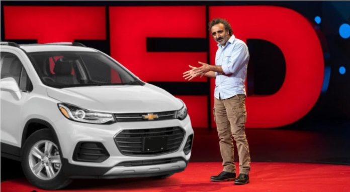 A white 2021 Chevy Trax on stage at a Ted Talk.