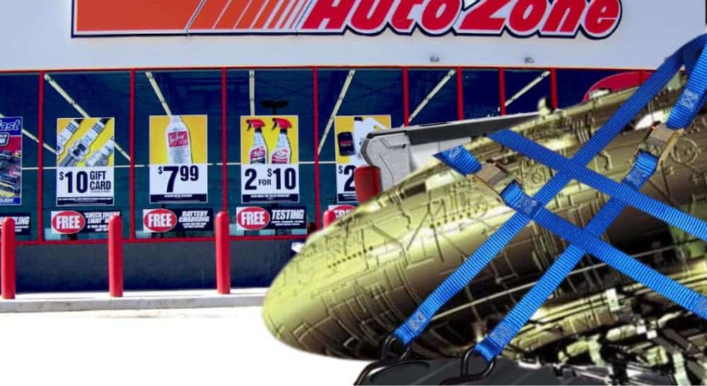 A spaceship wreckage has been towed in front of an Autozone.
