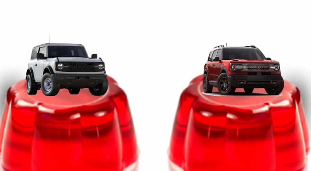 Two Ford Broncos are parked on top of Jello mounds after the 2021 Ford Bronco vs 2021 Ford Bronco Sport comparison.