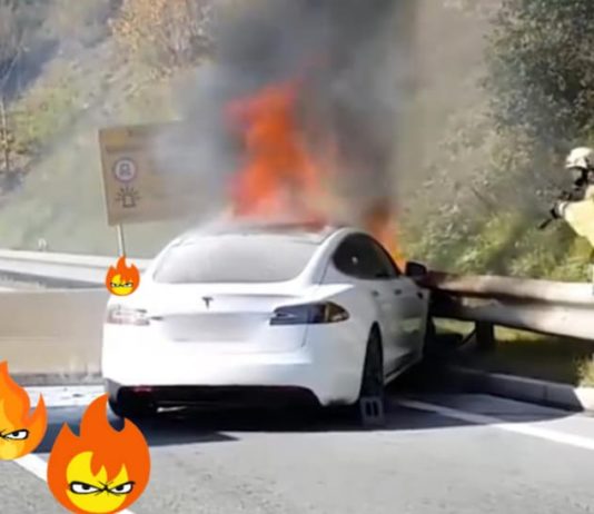 A Tesla has a car fire that is being put out by firefighters on the highway.