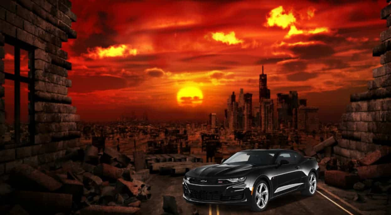 A black Chevy Camaro is parked in front of a red apocalyptic ruin.