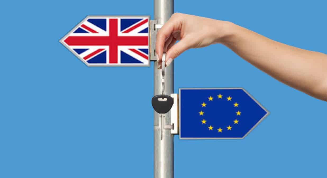 A key is in front of a sign with the English and European flags.