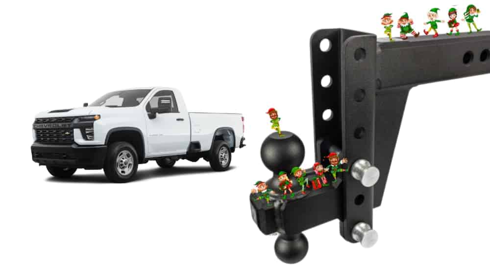 A white 2021 Silverado diesel is shown next to a trailer hitch covered in elves.
