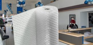 A large roll of bubble wrap is shown in the showroom of a Chevy dealership.