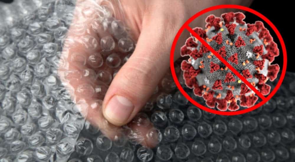 A hand it shown popping bubble wrap next to a general prohibition sign over a virus cell.