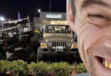 A man 's face with gold teeth is in front of a Jeep dealer in California.