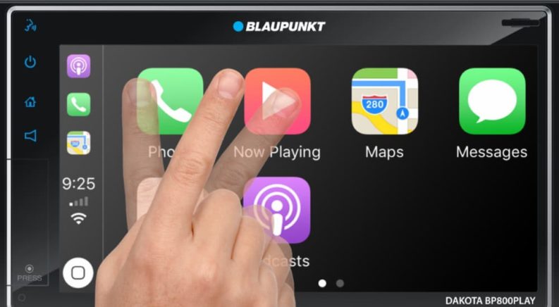 A close up shows an audio screen with a finger shaking back and fourth in front of it.